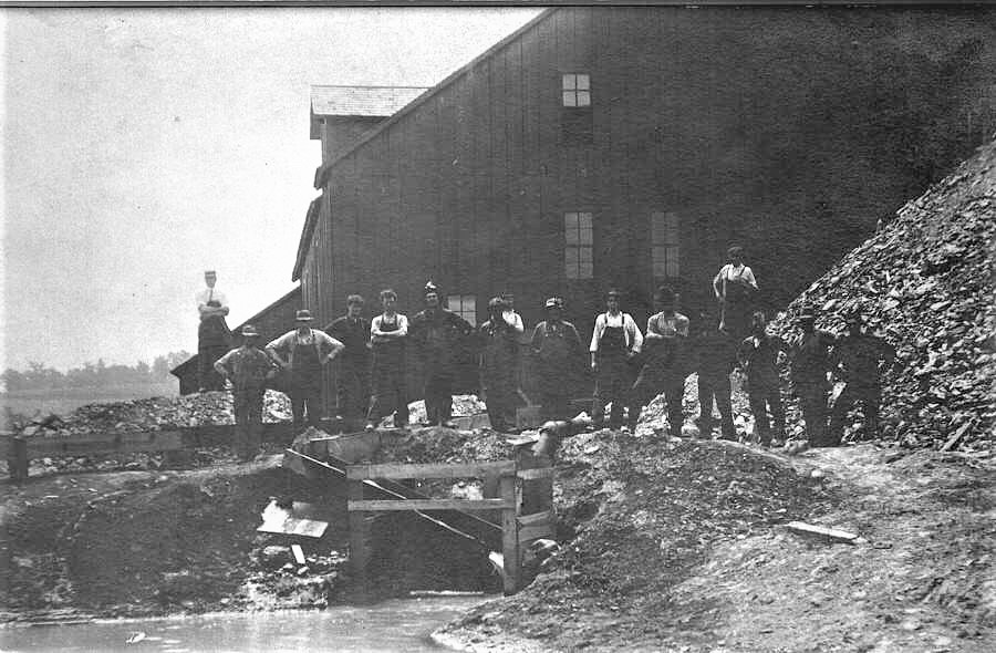 Miners at the Lucky 12 in New Diggings, WI proudly stand among the lead piles.